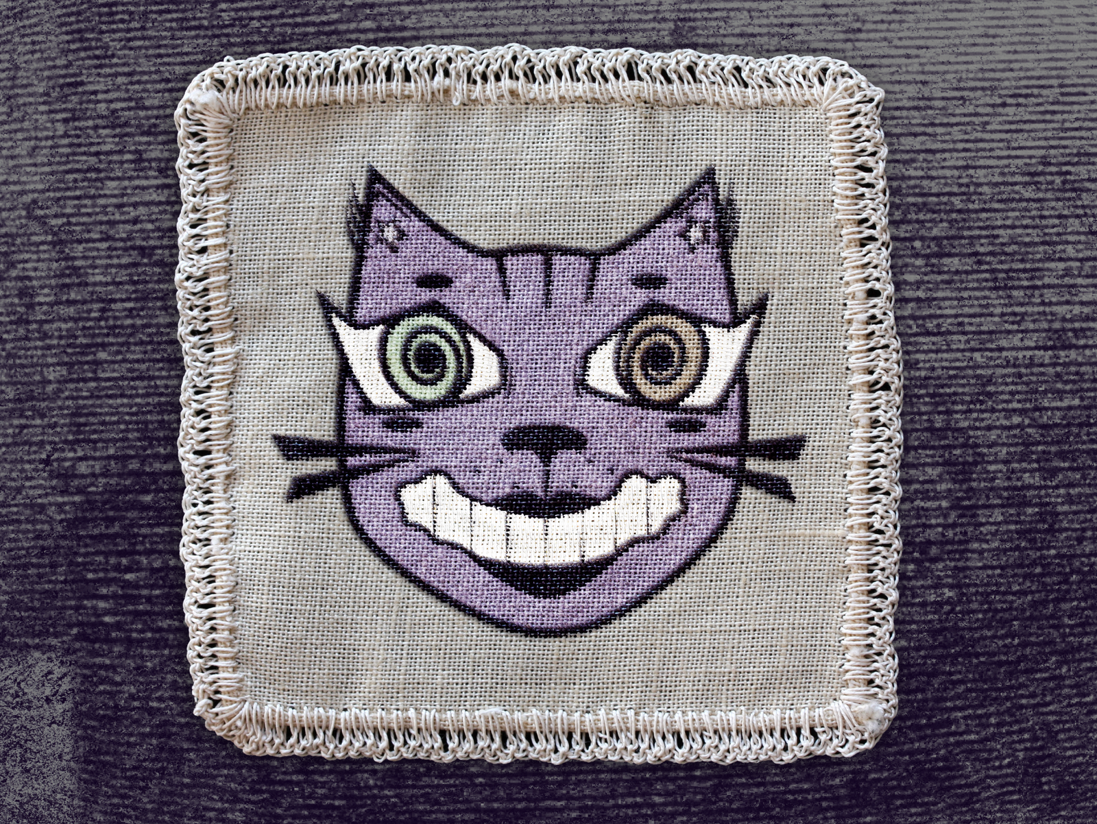 Edited embroidered Curiosity Kissed Cat logo